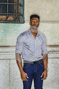 Young black man standing on street in New York City, thinking