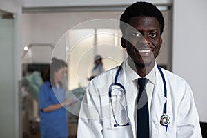 Portrait of african american man working at hospital ward desk
