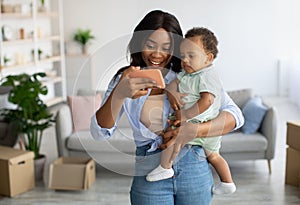 Portrait of african american mom using cellphone at home