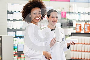 Portrait of a African-American pharmacist next to her colleague