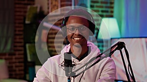 Portrait of african american podcaster smiling confident at camera while recording podcast