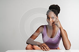 Portrait of african american woman looking aside while sitting