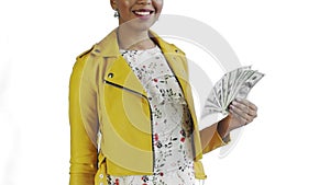 Portrait of african american woman with money fan on white Background in Studio. Yellow jacket