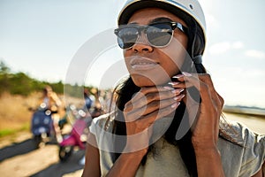 Portrait of african american woman putting on safety helmet