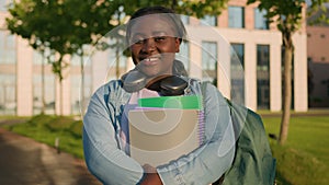 Portrait African American woman university college campus academy student teen girl high school pupil holding books with