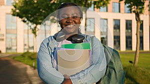 Portrait African American woman university college campus academy student teen girl high school pupil holding books with