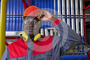 Portrait Of African American Worker In Protective Workwear In Industrial Interior