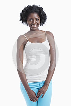 Portrait of an African American young woman standing over white background
