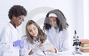 Portrait of african black and caucasian boy and girls studying science