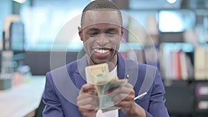 Portrait of African Businessman Counting Dollars