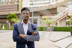 Portrait of African businessman outdoors in city