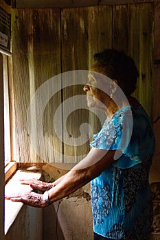 Portrait of African elderly woman by the window