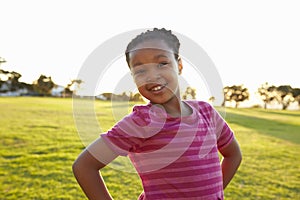 Portrait of African elementary school girl posing in a park