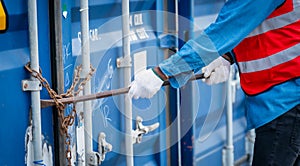 Portrait of African Engineer or foreman wears PPE checking container storage with cargo container background at sunset. Logistics