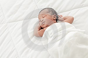 Portrait of african infant sleeping on bed