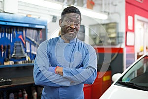 Portrait of african male mechanician posing in workshop