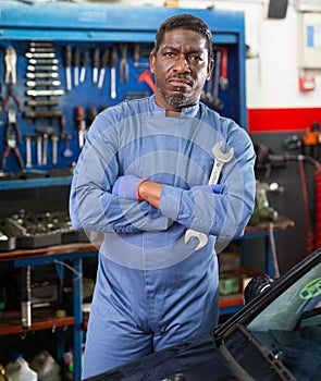 Portrait of african male mechanician posing in workshop