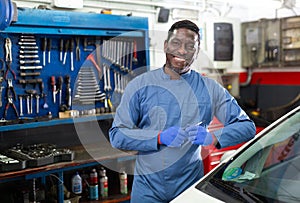 Portrait of african male mechanician posing in workshop