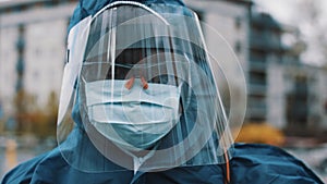 Portrait of an african man wearing NBC personal protective equipment ppe suit, mask, goggles and face shield. Preventing