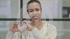 Portrait of African Woman showing Heart Shape by Hands