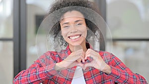 Portrait of African Woman showing Heart Shape by Hands