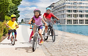 Cute African girl riding bicycle with her friends