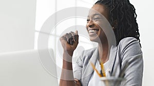 Portrait Of Afro Business Lady Laughing Sitting Against Window