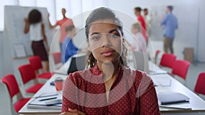 Serious afro woman posing camera office. Businesswoman standing meeting room