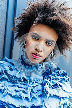 portrait of afro girl in blue clothes posing