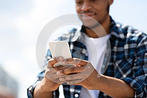 Portrait of afro person texting sms on his smart phone