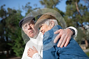 Portrait of aged couple spending time in park