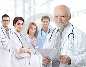 Portrait of aged doctor with medical residents