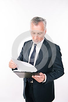 A portrait of aged focused man working with clipboard