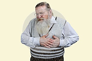Portrait of aged man touching his chest suffering from heart attack.