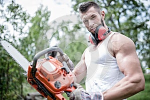Portrait of aggressive muscular male lumberjack, woodworker photo