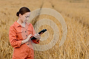 Portrait Agronomist farmer with digital tablet computer in wheat field