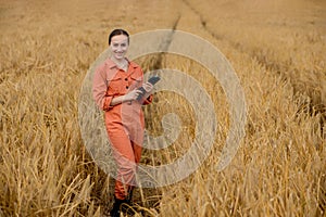 Portrait Agronomist farmer with digital tablet computer in wheat field.