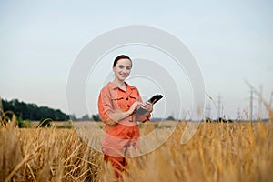 Portrait Agronomist farmer with digital tablet computer in wheat field