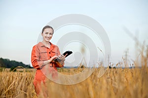 Portrait Agronomist farmer with digital tablet computer in wheat field