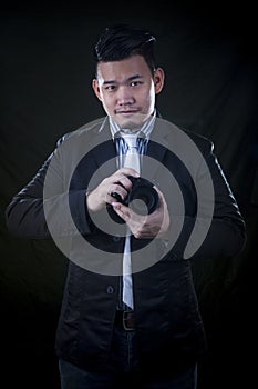 Portrait of aisan younger man with dslr camera in hand photograp