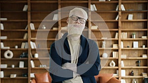 Portrait of albino man posing in the office. Handsome businessman crossing arms