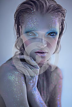 Portrait of alien woman with glitter make up