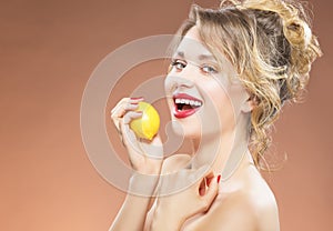 Portrait of Alluring Caucasian Blond Girl Biting Lemon