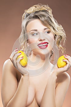 Portrait of Alluring Caucasian Blond Girl With Two Lemons