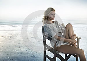 Portrait of an alluring woman sitting on the retro chair