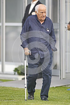 Portrait of Amancio Ortega leaning on a crutch