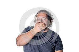 Portrait of amazed man covering his mouth over white background