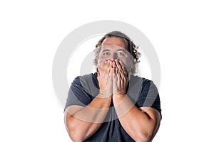Portrait of amazed man covering his mouth over white background