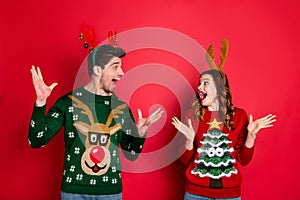 Portrait of amazed two masquerade people wife husband with brunet hair hear news scream wow wear seasonal christmas tree