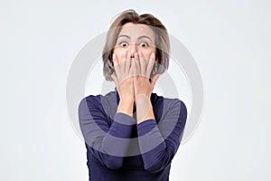 Portrait of amazed young woman over white background